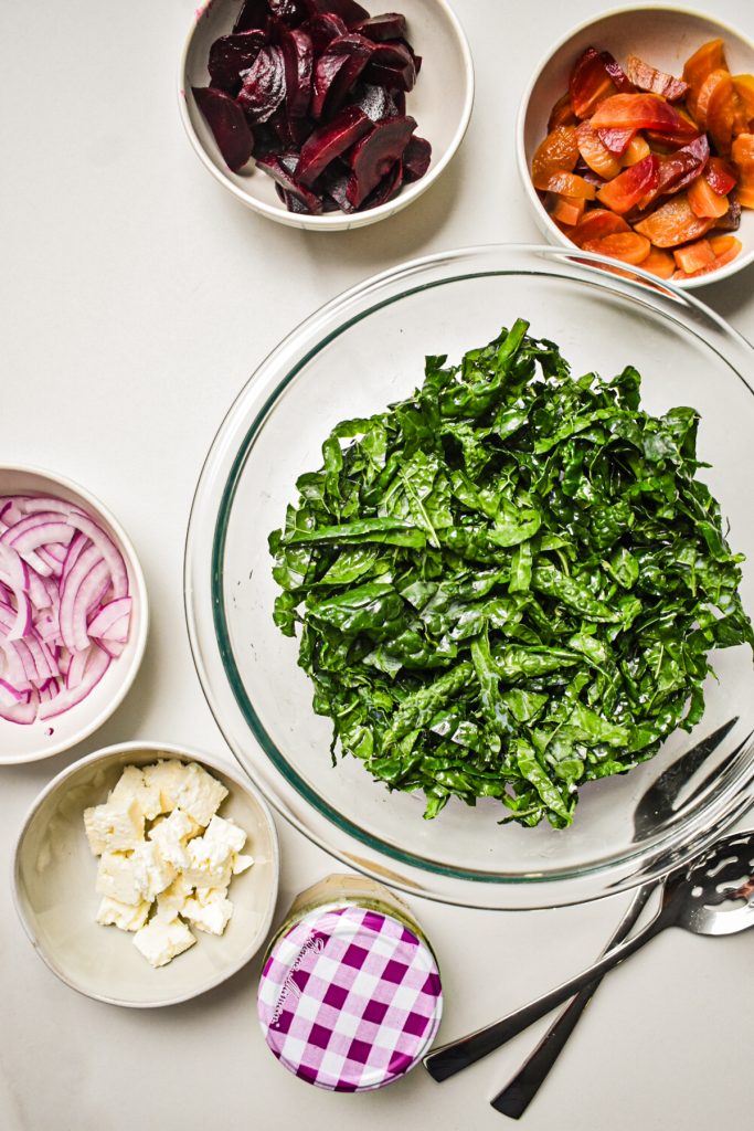 View of ingredients, kale, onion, beets, feta cheese.