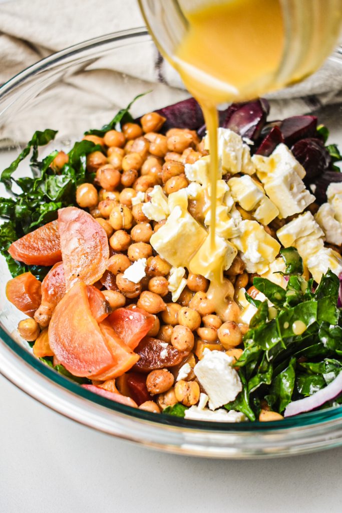 View of pouring dressing over the salad.
