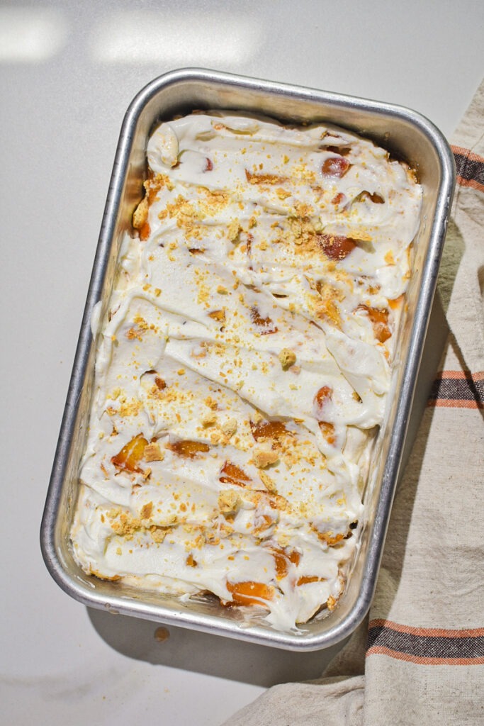 Peaches combined with the whipped cream mixture and placed in a loaf pan to freeze.