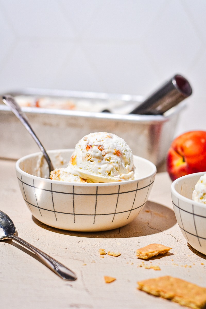 Side view of a bowl of peach cobbler ice cream.