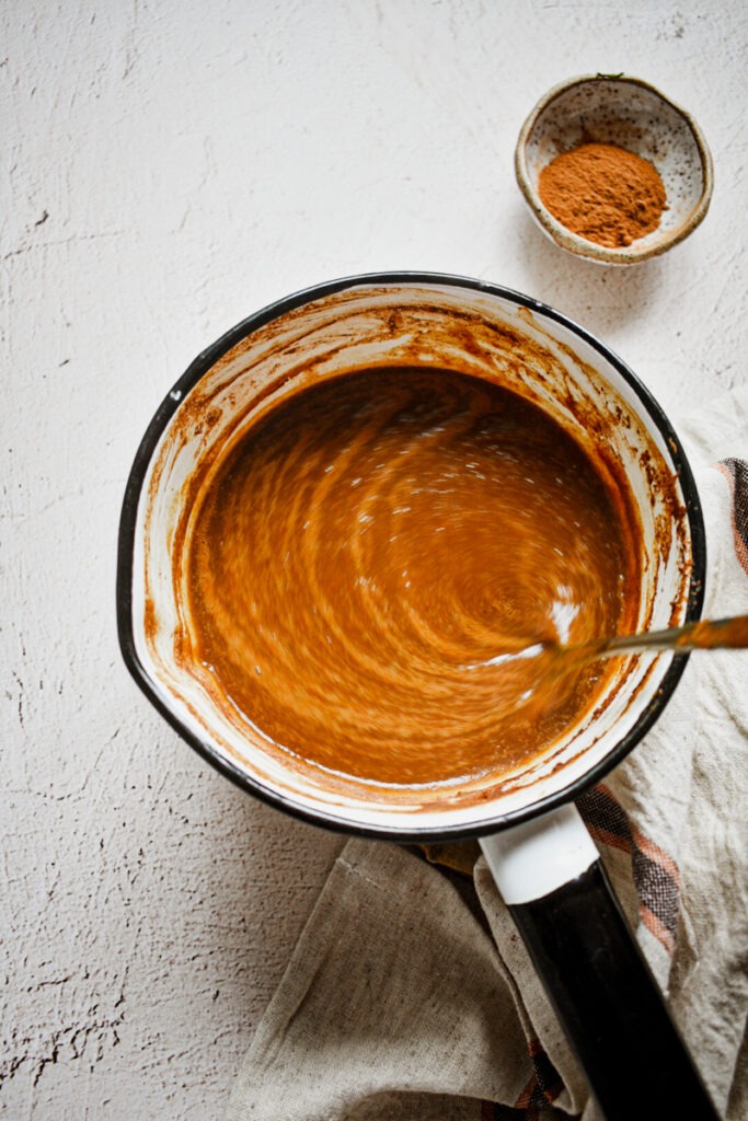 Mixing together the homemade pumpkin sauce in a sauce pan.