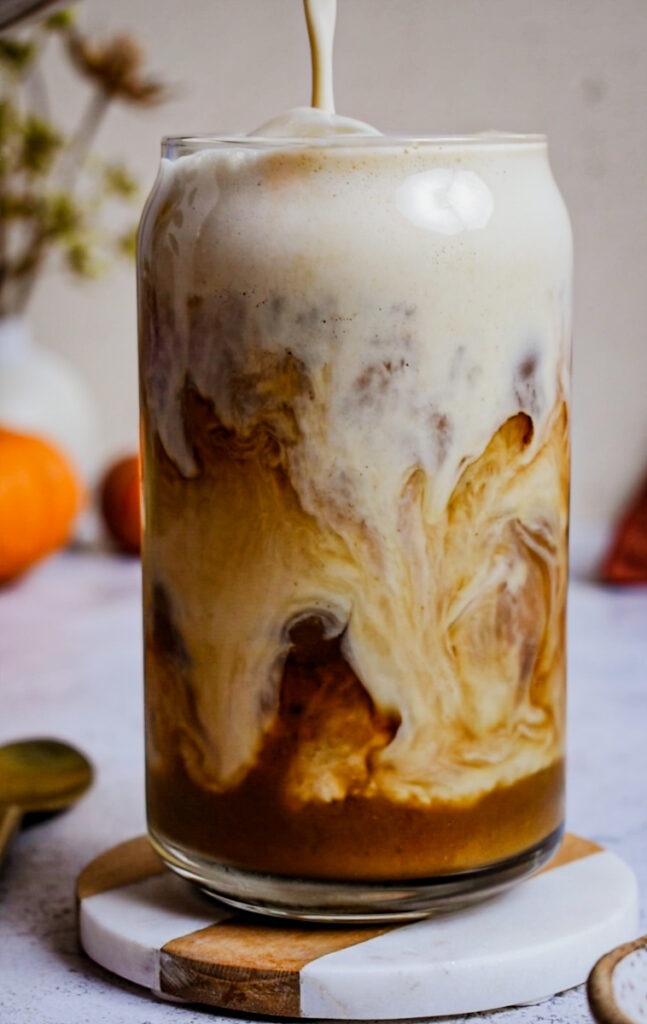 Side view of an ice coffee with pumpkin sauce.