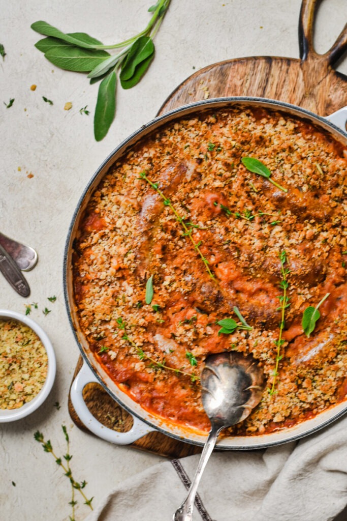 Overhead shot of white bean and sausage cassoulet with a spoon.