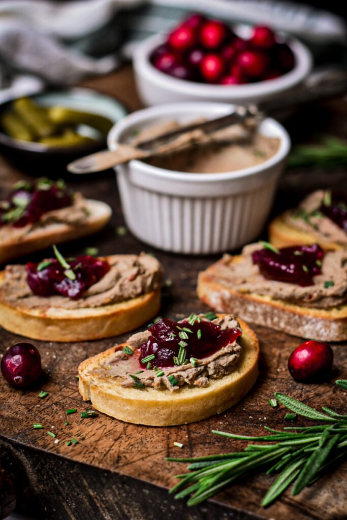 Chicken liver pate on crostini with cranberry jam on top.