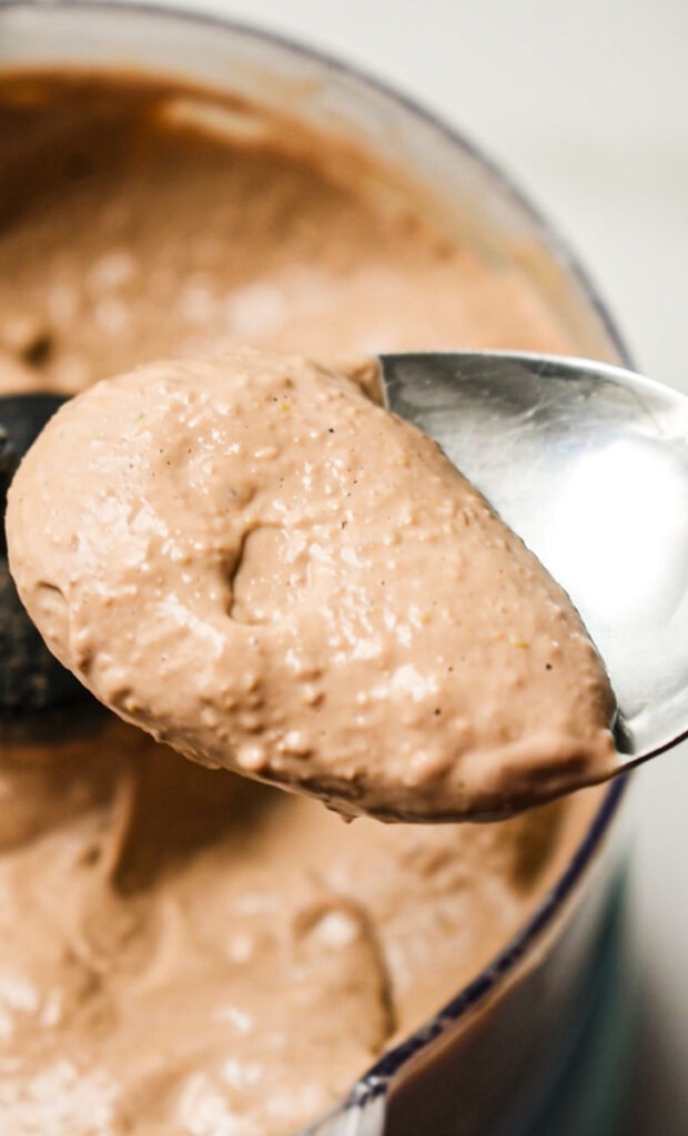 Spoonful of creamy pâté with the rest in a food processor below it.