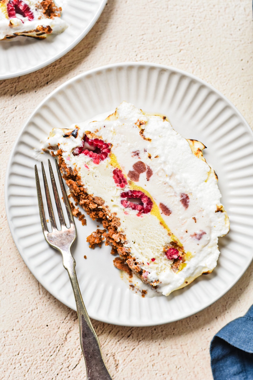Overhead shot of a slice of baked Alaska cake on a plate.