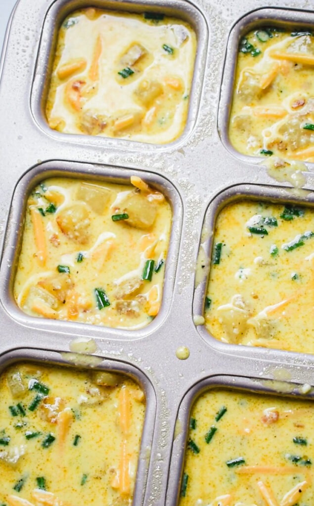 Egg potato cheddar mixture added to the brownie cake pan.