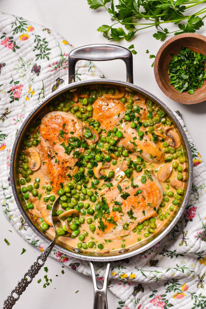 shot of skillet full of delicious mustard chicken with creamy mushroom sauce