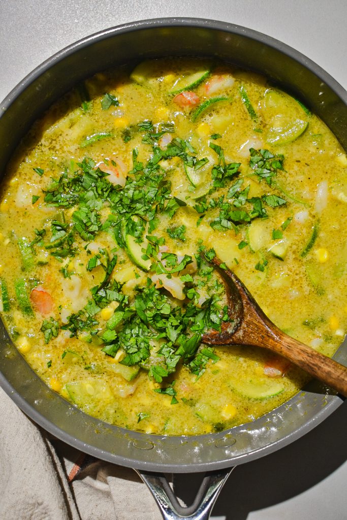 simmering pot of shrimp zucchini corn chowder topped with cilantro