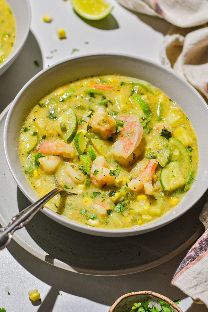 Bowl full of shrimp corn and zucchini chowder soup