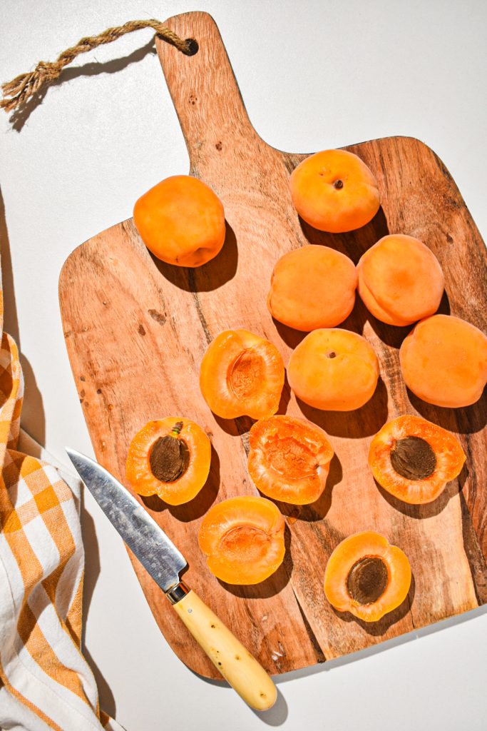 wooden board with slices of juicy apricots