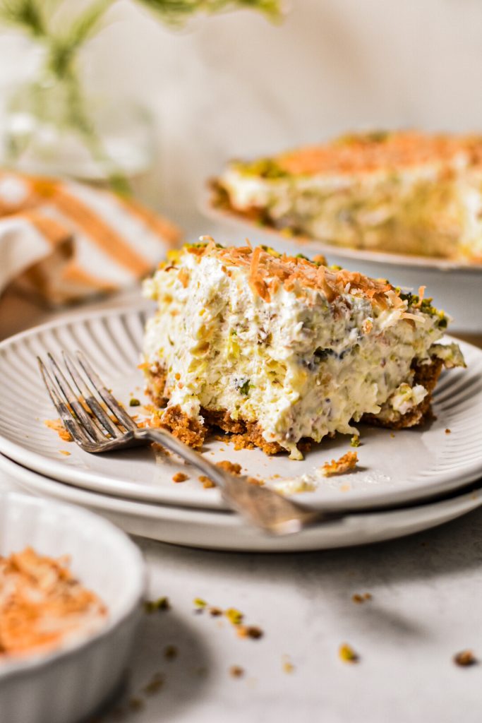 Slice of million dollar pie on a plate with a bite missing.