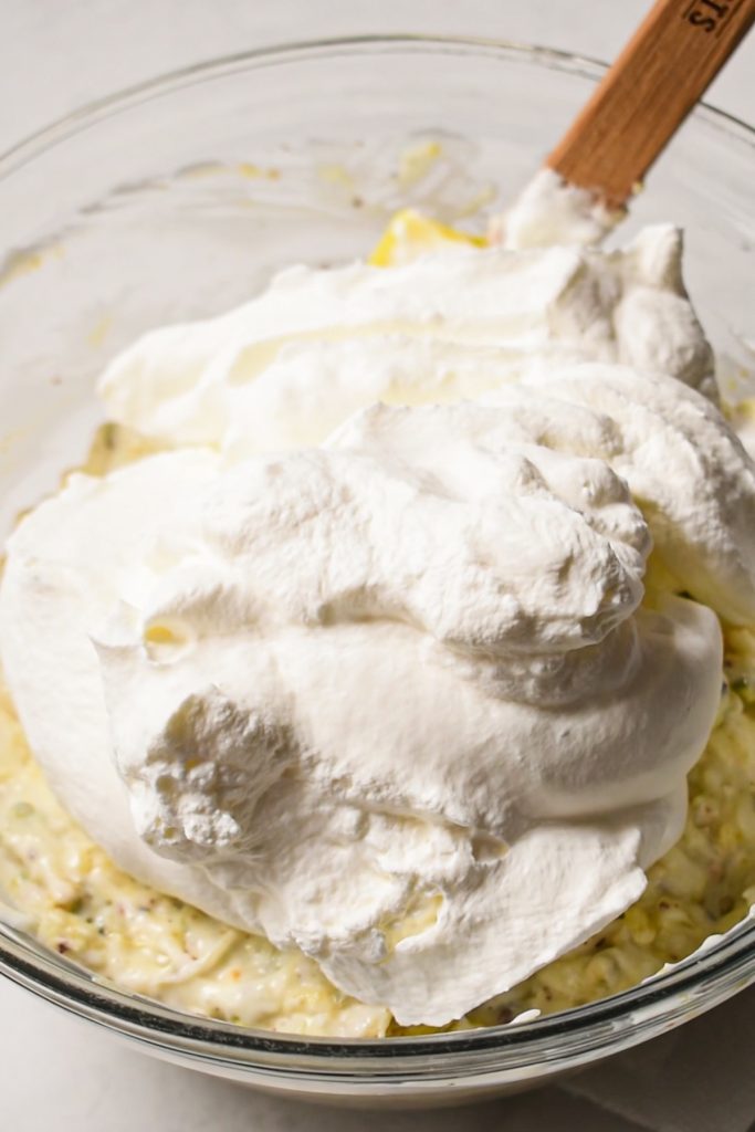 Adding the whipped cream to the pie filling.