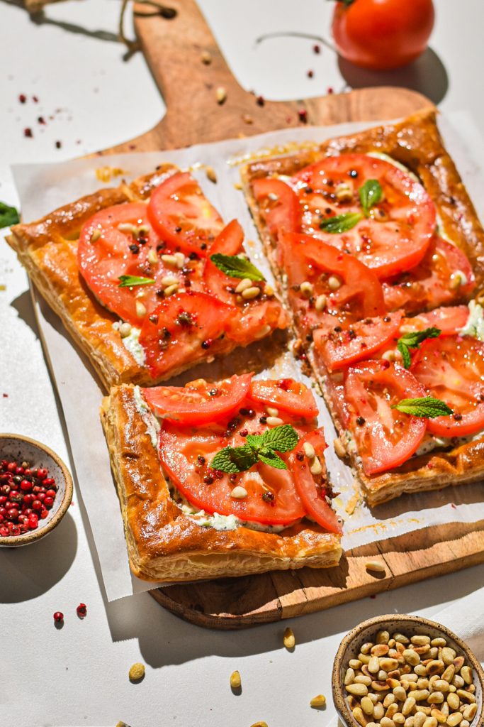 Puff pastry tart with feta, tomato, pine nuts, pepper and fresh mint on top.