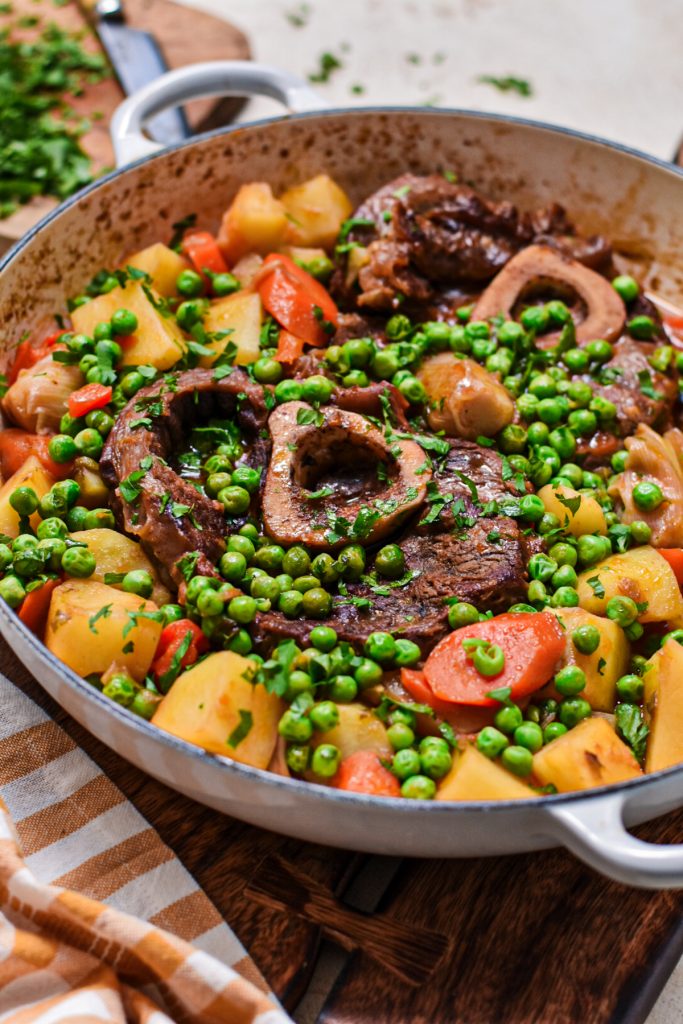 Osso buco stew with potatoes and peas after being cooked.