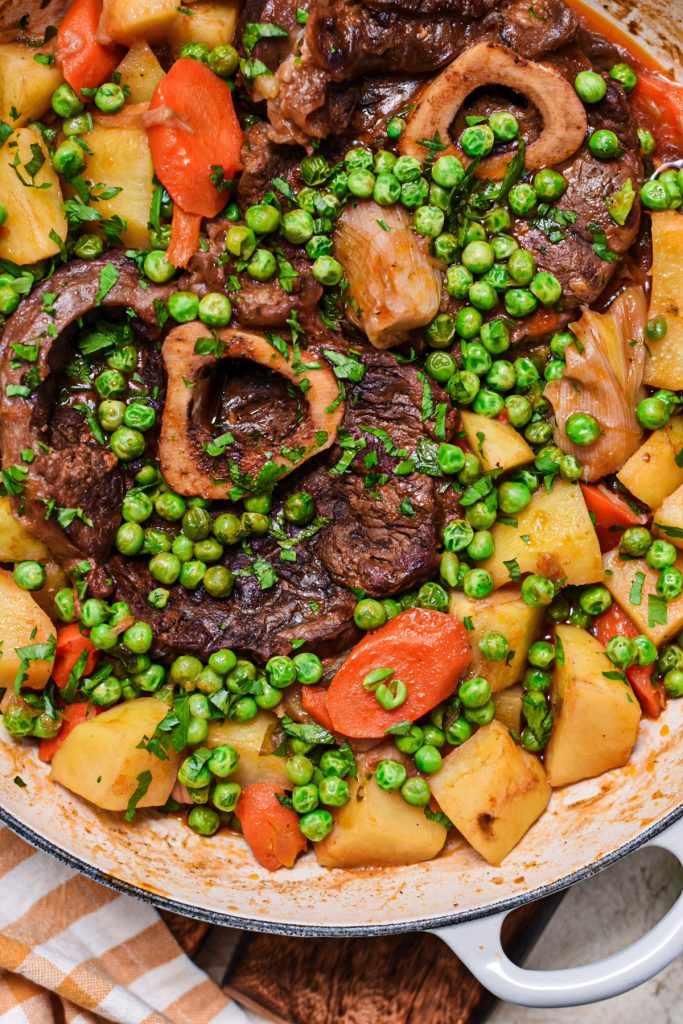 Close up shot of spring stew osso bucco in a dutch oven pot.