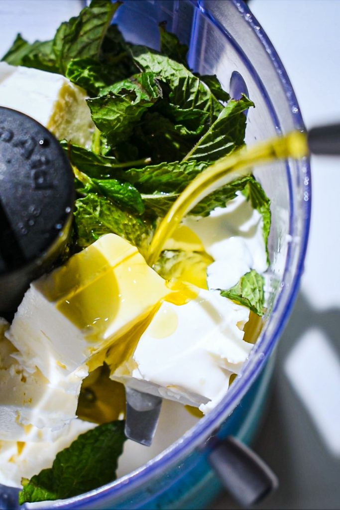 Feta, mint, cream, lemon juice and olive oil in a food processor before being blended.