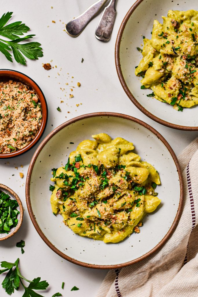 Beer cheese poblano mac and cheese served in two bowls.