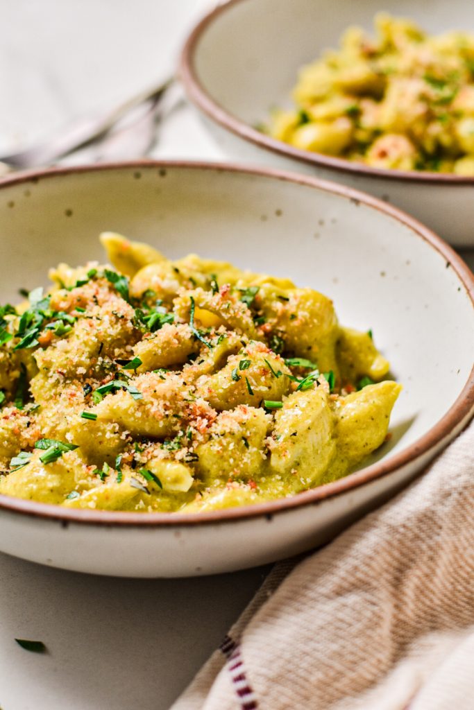 Side view of two bowls of poblano beer cheese mac and cheese.