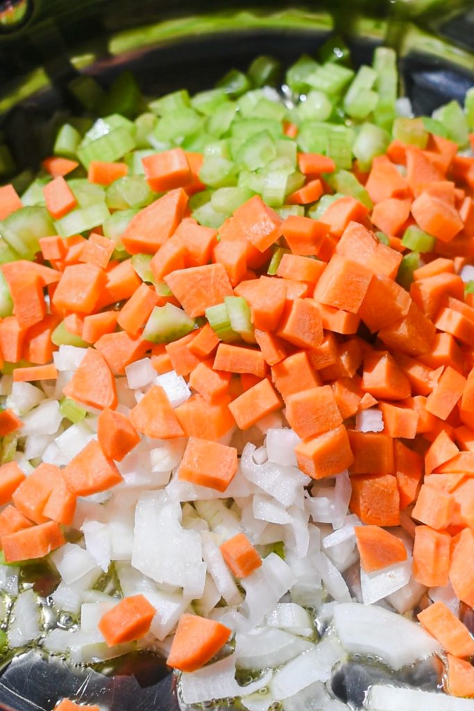 Cooking the mirepoix in a skillet with olive oil.
