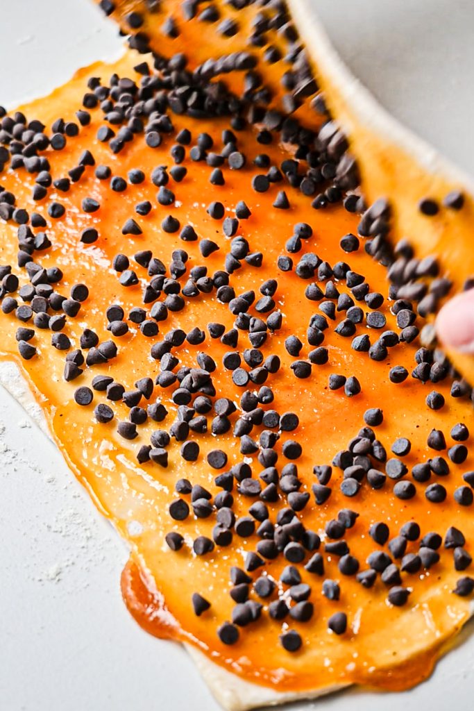 Folding the puff pastry in half with pumpkin butter and chocolate chips inside.