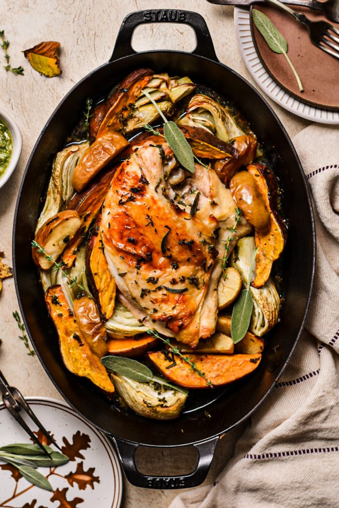 Overhead shot of roasted turkey breast with vegetables in a roasting pan.