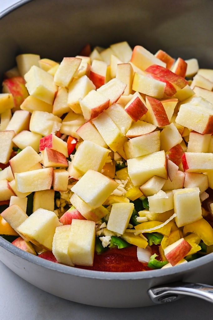 Chopped apples added to the other ingredients in a sauce pan.