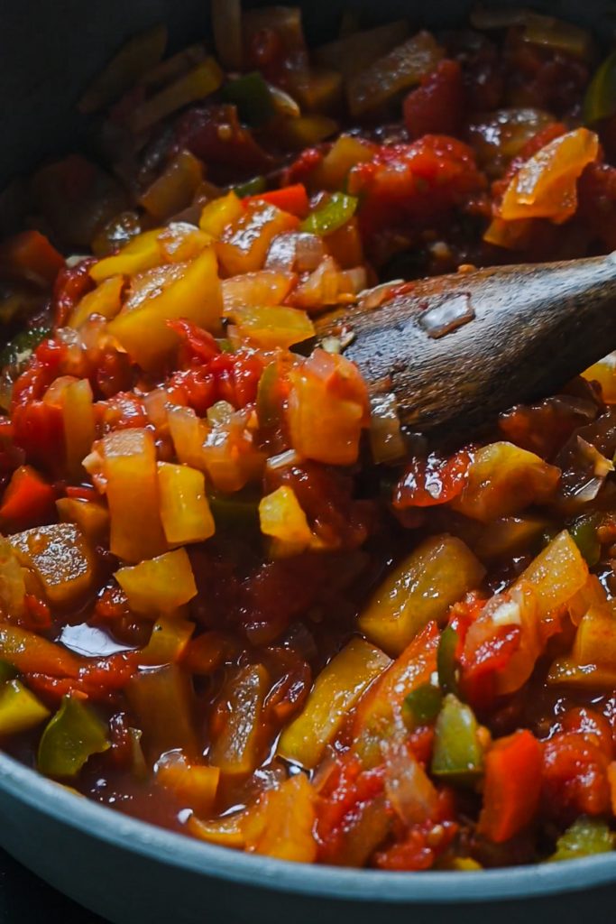 Using a wooden spoon to stir the Southern apple salsa while cooking.