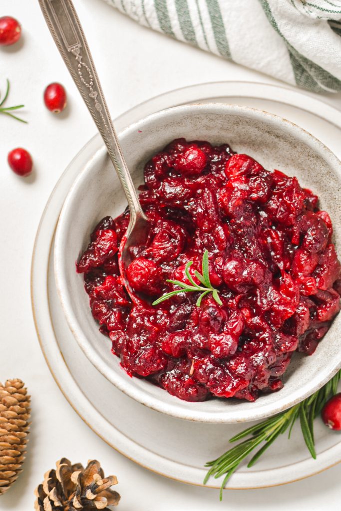Overhead shot of ginger balsamic roasted cranberry sauce in a serving bowl.
