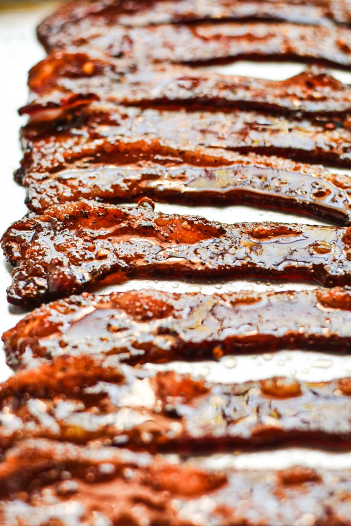 Million dollar bacon lined up on a baking sheet after being baked.