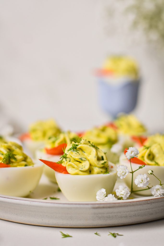 Side view of farmers cheese deviled eggs served on a serving platter.