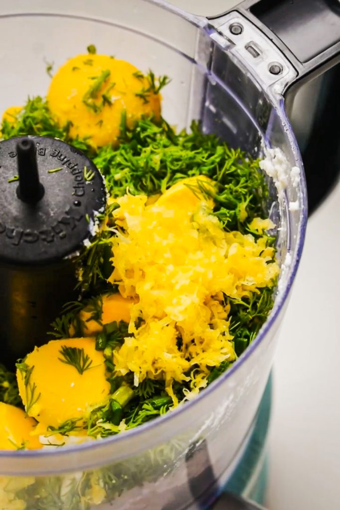 Deviled egg filling ingredients in a food processor before being mixed.
