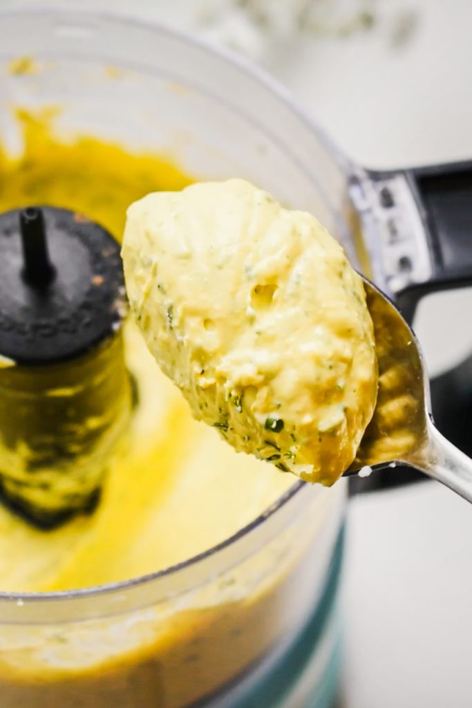 Spoon lifting up the fluffy deviled egg filling to the camera.