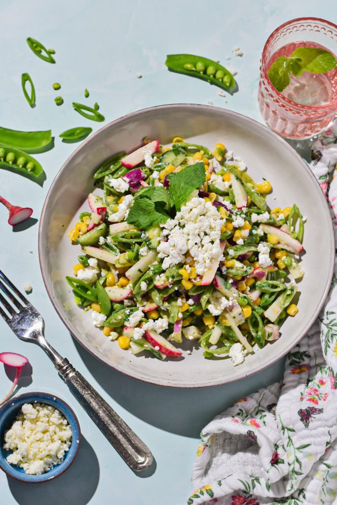 Serving of sugar snap pea salad in a shallow grey bowl.