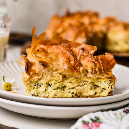 Side view of farmer cheese phyllo pie with a ruffle of crispy phyllo on top.