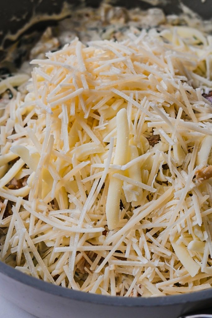 Shredded mozzarella and parmesan cheese added to the spinach artichoke mixture.