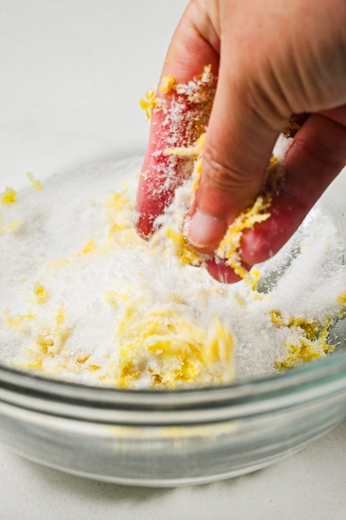 Hand rubbing the lemon zest and sugar together.