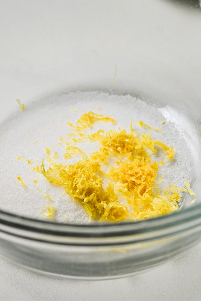 Sugar and lemon zest in a bowl.