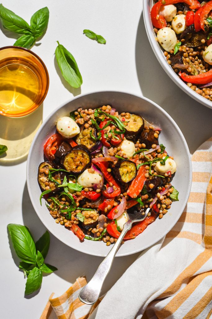 Overhead shot of a bowl of lentil salad with roasted eggplants.