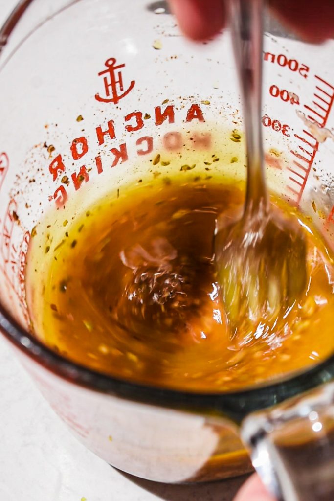 Making the marinade for pork souvlaki in a measuring cup.