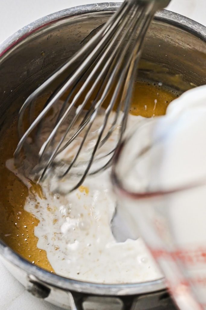 Whisking in the milk into the butter and flour mixture.