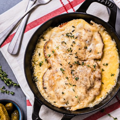 Overhead shot of croûte au fromage in a cast iron skillet.