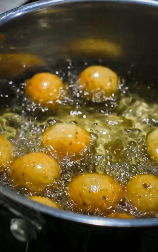 Polpette di parmigiano frying in oil.