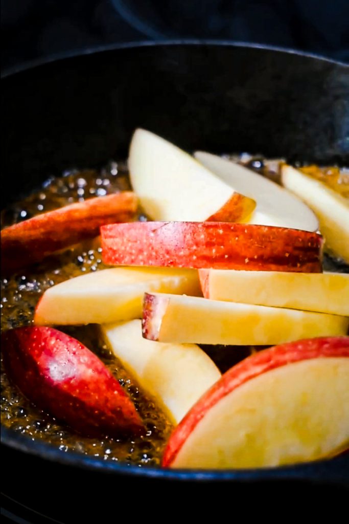 Fresh apples added to the sugar and butter in the cast iron skillet.