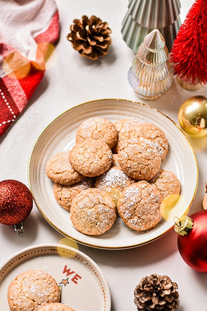 Macarons de Nancy served on a plate with Christmas themed decorations around them.