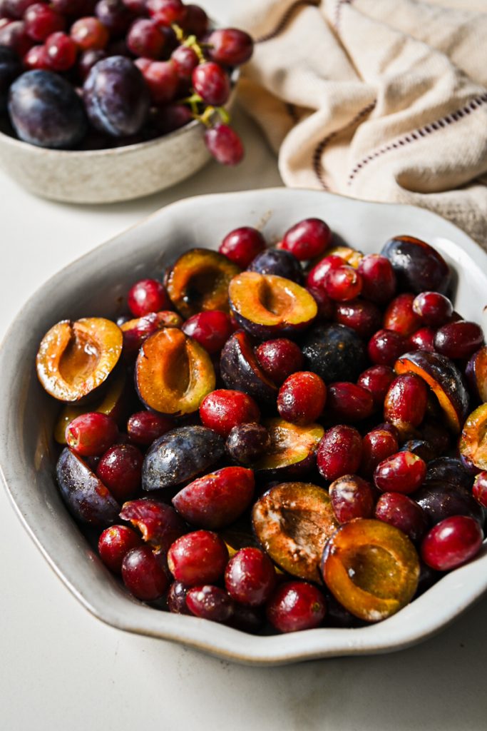 Macerated fruits added to a pie dish.
