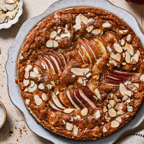 Overhead view of a spiced pear French cake on a large plate.