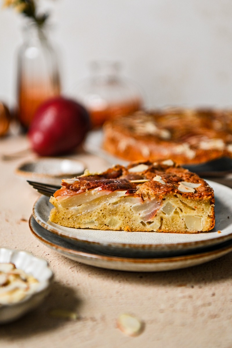 Slice of spicy pear French cake on a plate.