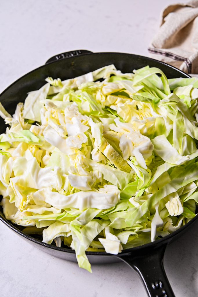 Chopped cabbage in a cast iron skillet.