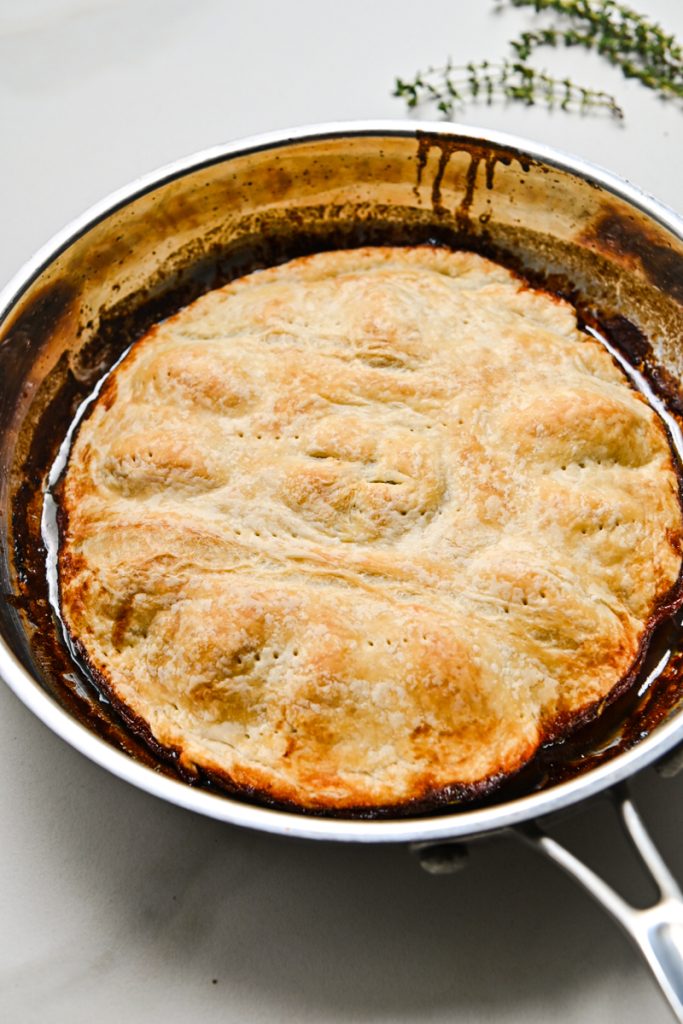 Baked red wine onion tarte tartin in a skillet.